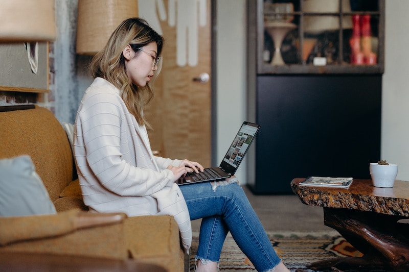 Woman on laptop in her living room.